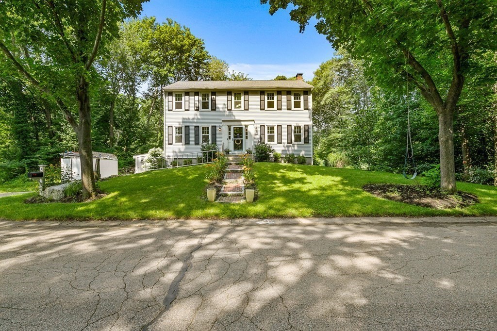3 Chatham Circle Hingham, MA 02043 - Photo 6 of 36 a view of a house with a yard and lawn chairs under an umbrella