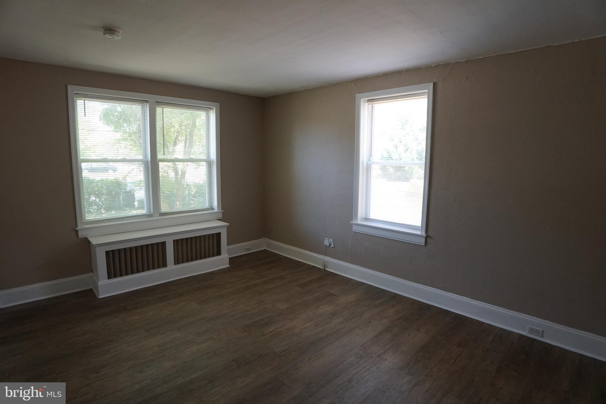 2 Aigburth Road, Unit 1 Towson, MD 21286 - Photo 3 of 10 a view of an empty room with wooden floor and a window