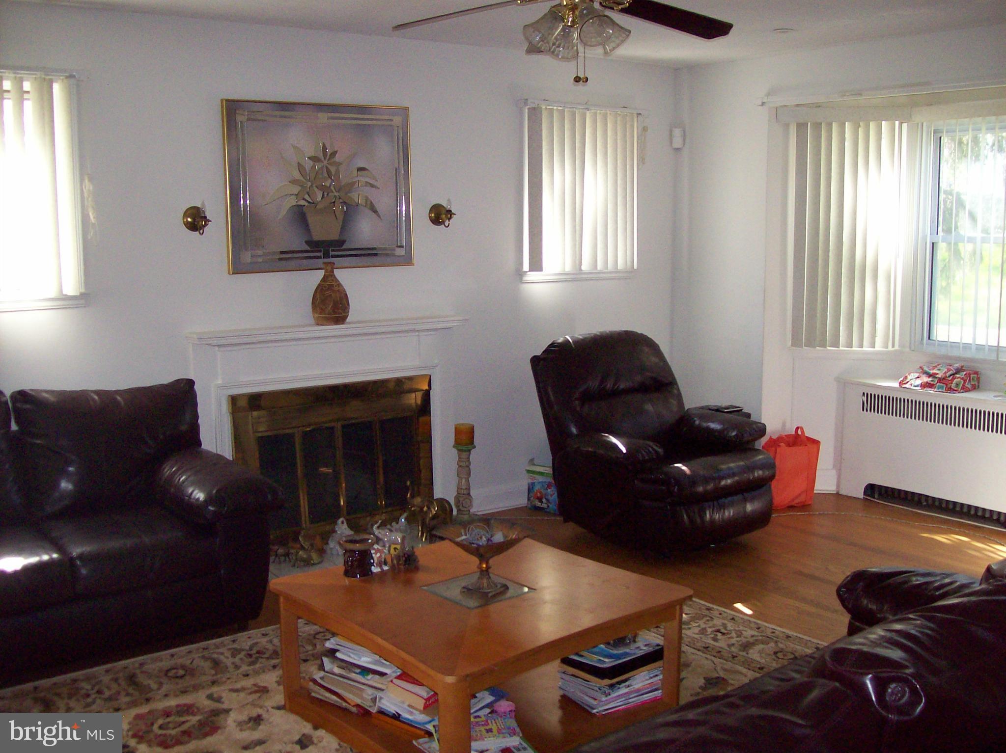 1534 Northwick Road Baltimore, MD 21218 - Photo 3 of 12 a living room with furniture and a fireplace
