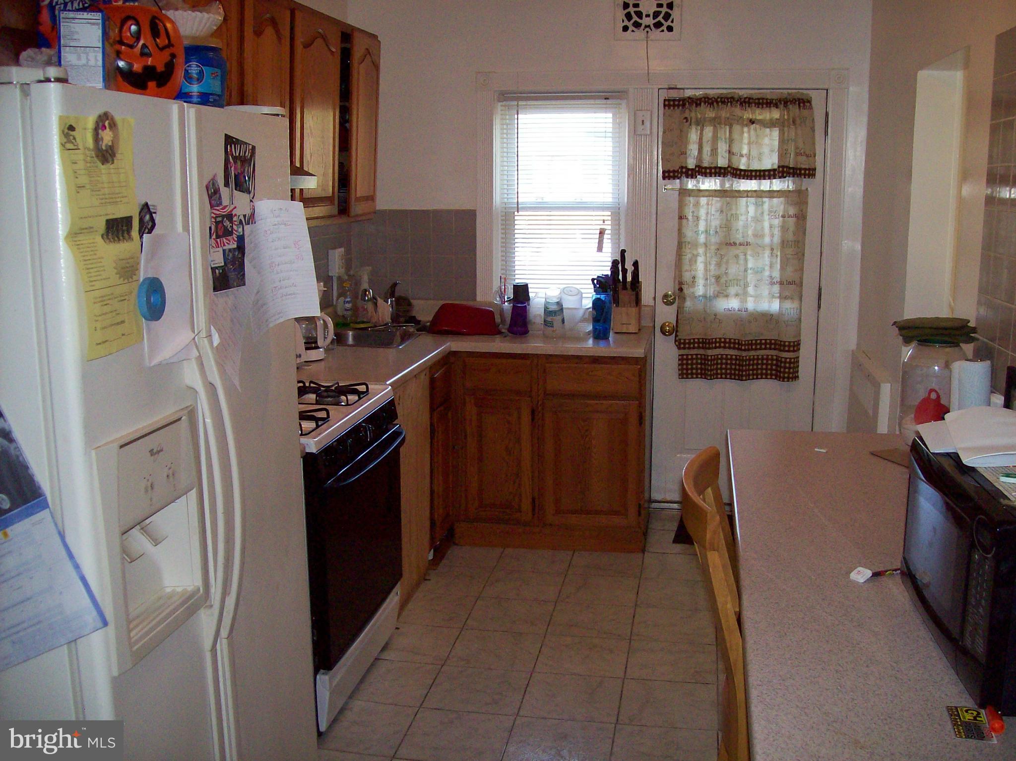 1534 Northwick Road Baltimore, MD 21218 - Photo 5 of 12 a kitchen with stainless steel appliances granite countertop a stove a refrigerator and a wooden cabinets