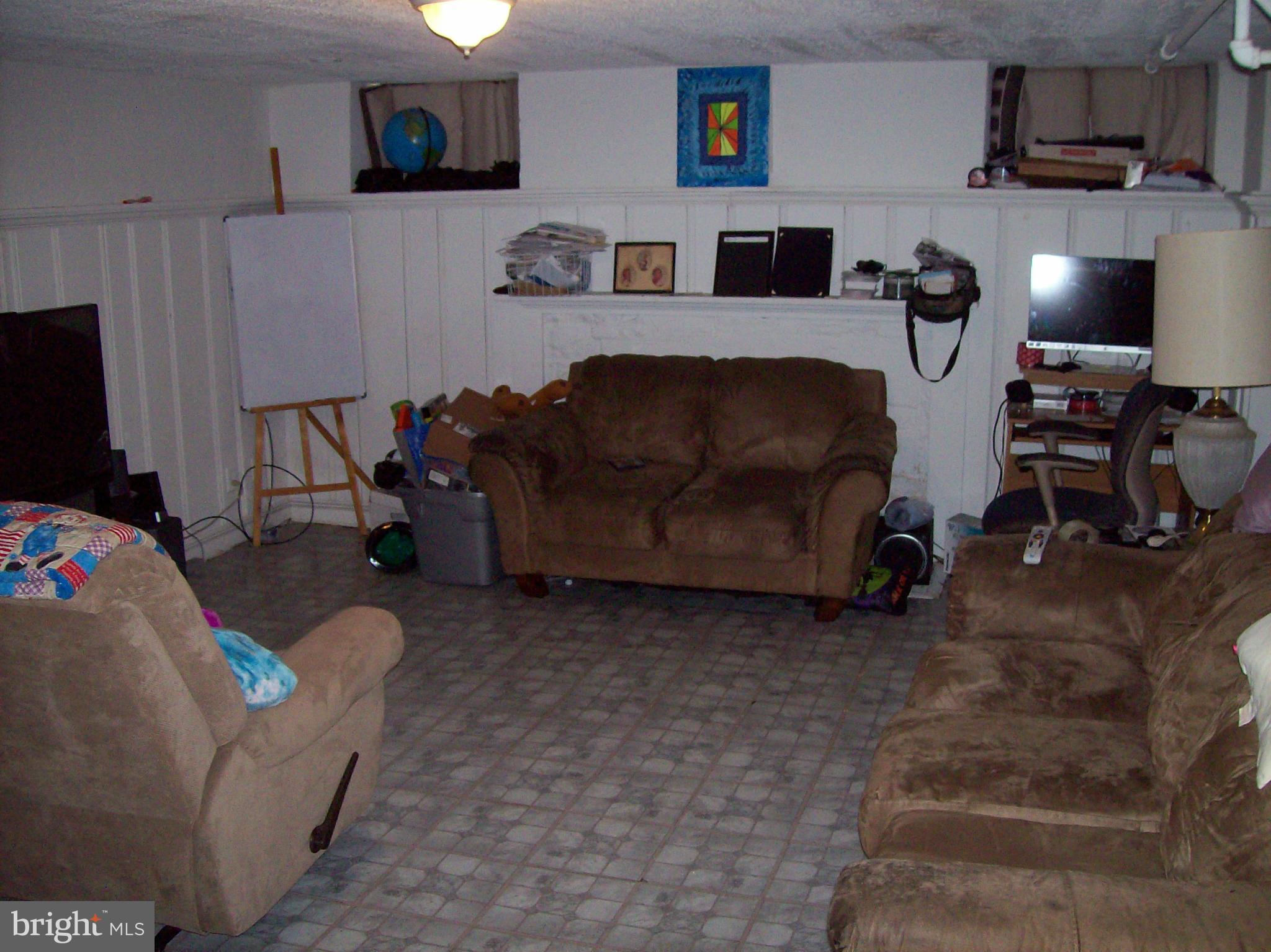 1534 Northwick Road Baltimore, MD 21218 - Photo 6 of 12 a living room with furniture and a flat screen tv