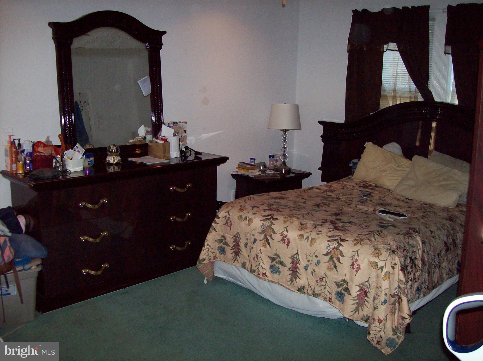 1534 Northwick Road Baltimore, MD 21218 - Photo 7 of 12 a bedroom with a bed and a mirror