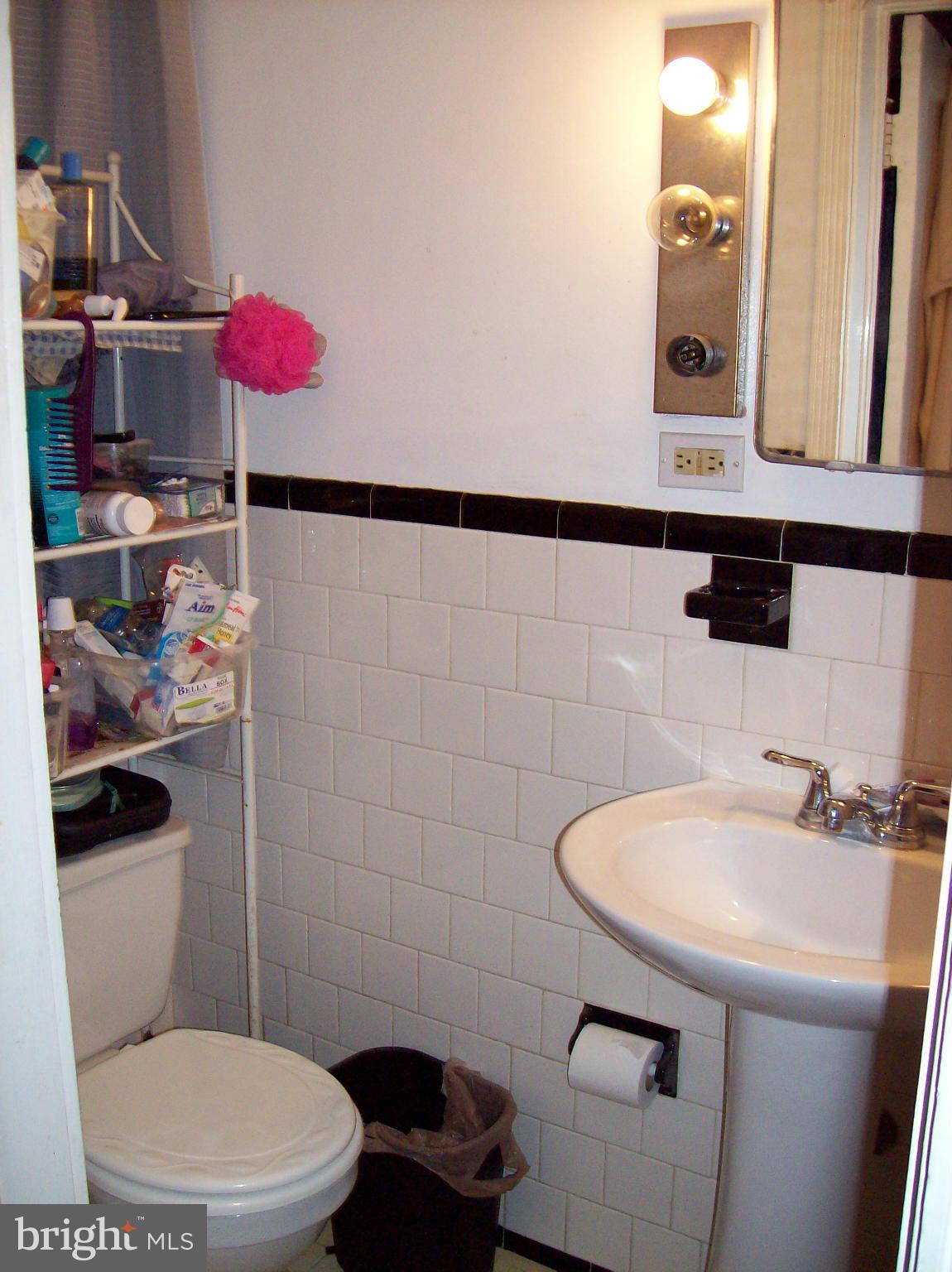 1534 Northwick Road Baltimore, MD 21218 - Photo 8 of 12 a bathroom with a sink a toilet and a mirror
