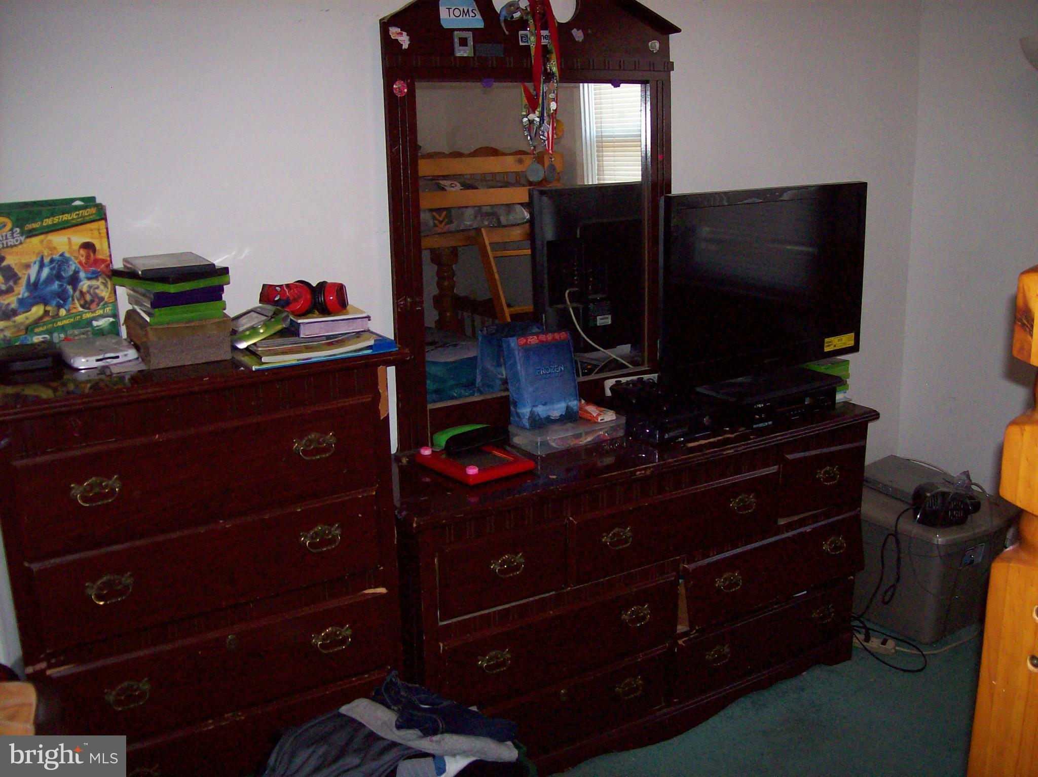 1534 Northwick Road Baltimore, MD 21218 - Photo 10 of 12 a room with a flat screen tv and a dresser