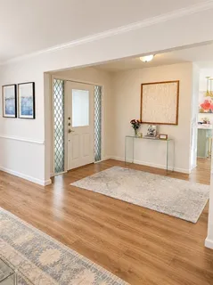 a view of a room with wooden floor and cabinet