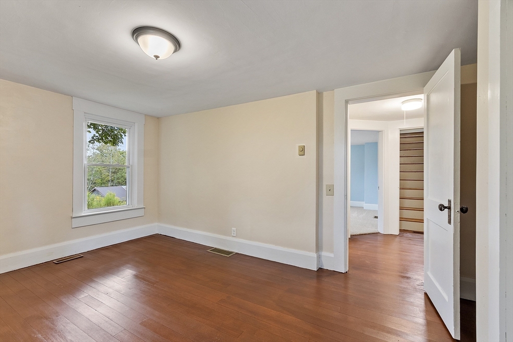175 Petersham Road Phillipston, MA 01331 - Photo 11 of 42 an empty room with wooden floor and windows