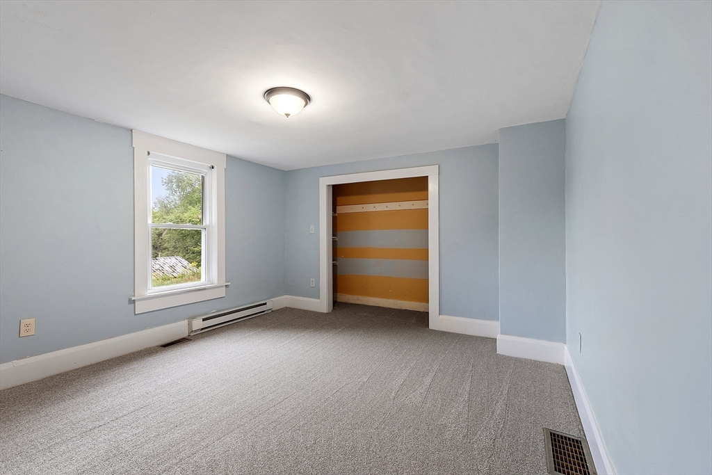 175 Petersham Road Phillipston, MA 01331 - Photo 14 of 42 an empty room with closet and windows