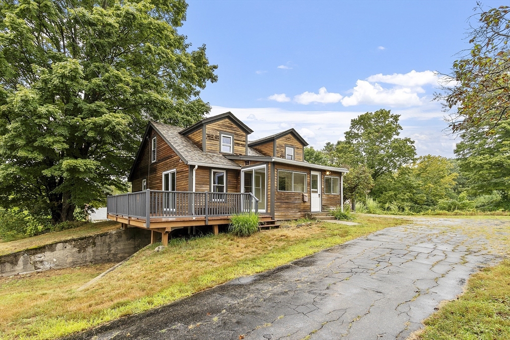 175 Petersham Road Phillipston, MA 01331 - Photo 2 of 42 a front view of a house with a yard table and chairs