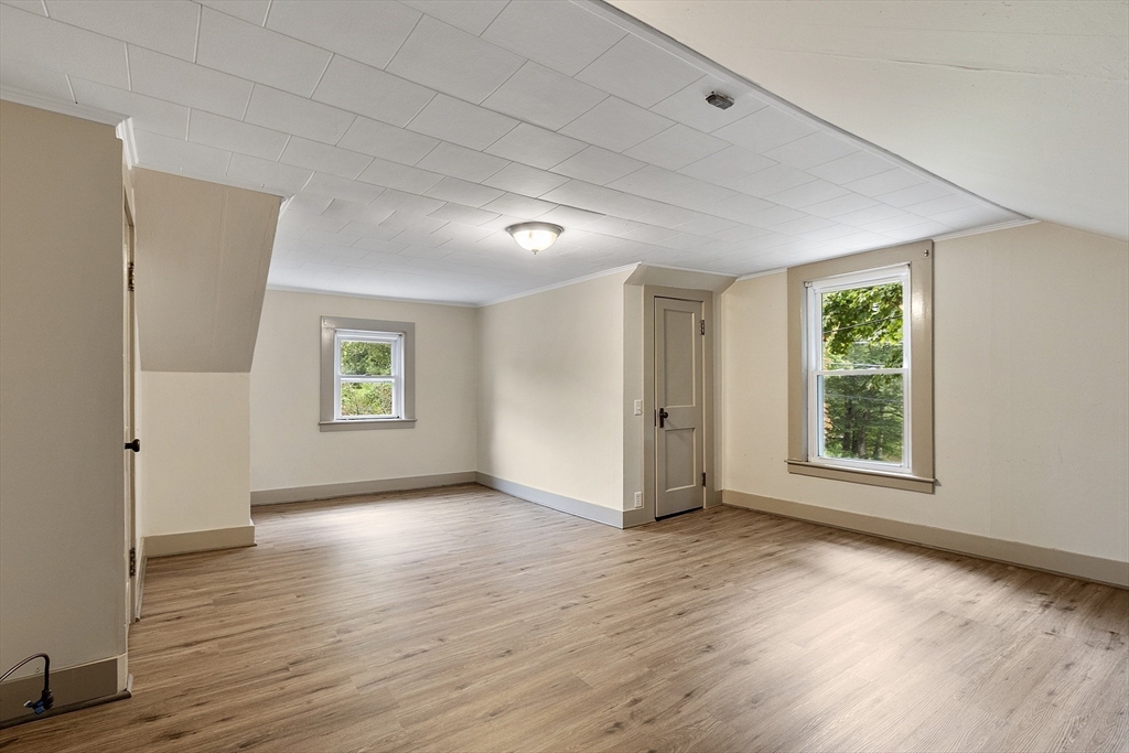 175 Petersham Road Phillipston, MA 01331 - Photo 24 of 42 an empty room with wooden floor and windows