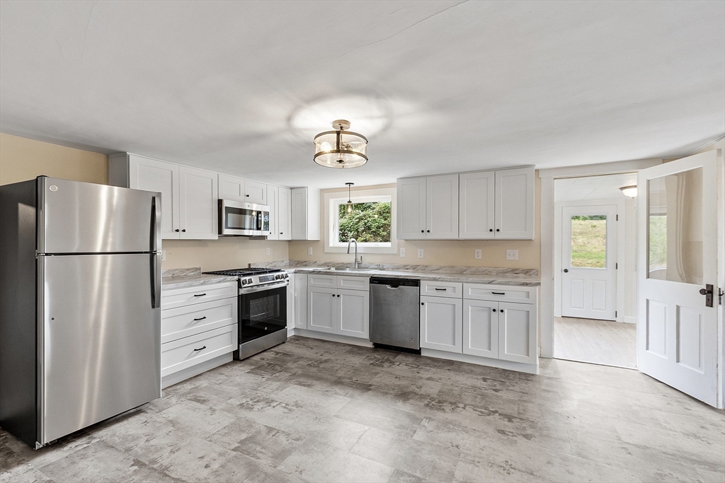 175 Petersham Road Phillipston, MA 01331 - Photo 3 of 42 a kitchen with white cabinets and white appliances