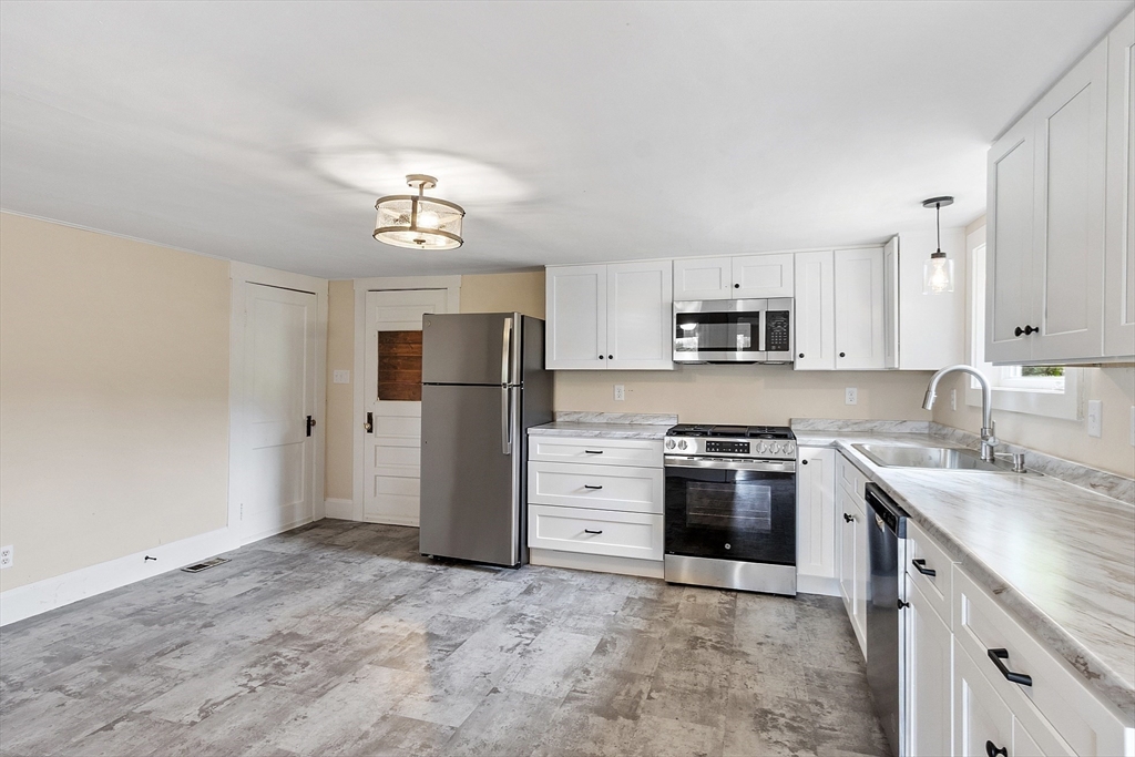 175 Petersham Road Phillipston, MA 01331 - Photo 4 of 42 a kitchen with stainless steel appliances granite countertop a stove a refrigerator and a sink