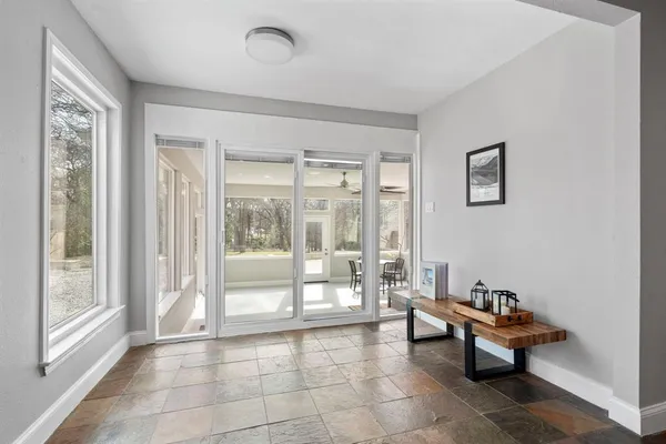a living room with furniture and a floor to ceiling window