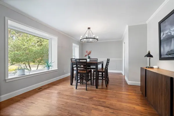a view of a dining room with furniture window and wooden floor