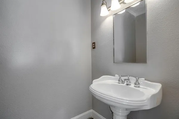 a bathroom with a sink a mirror and a toilet