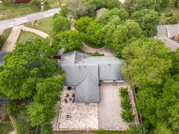 an aerial view of a house with a yard and lake view