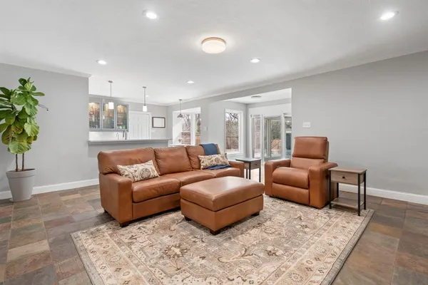 a living room with furniture a couch and a potted plant