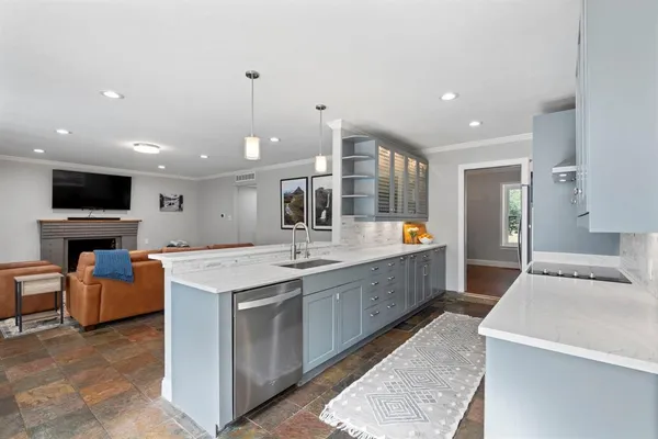 a large kitchen with kitchen island a sink counter space and stainless steel appliances