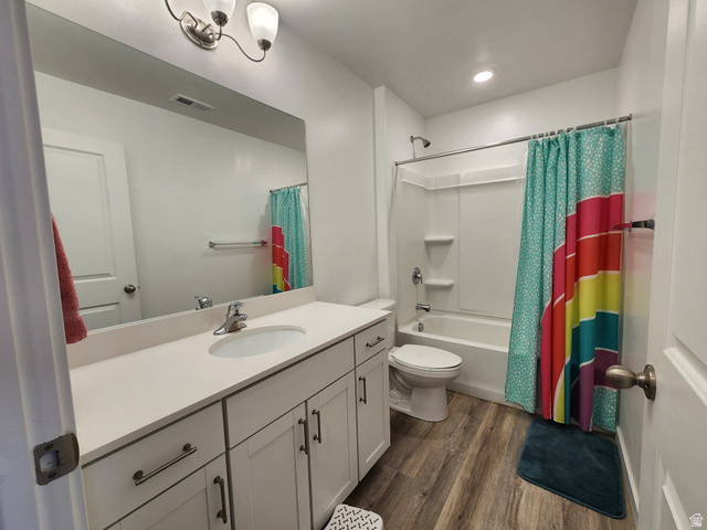 1736 East Fall Street Eagle Mountain, UT 84005 - Photo 12 of 30 Bathroom featuring vanity, shower / bath combo, and dark wood-style floors