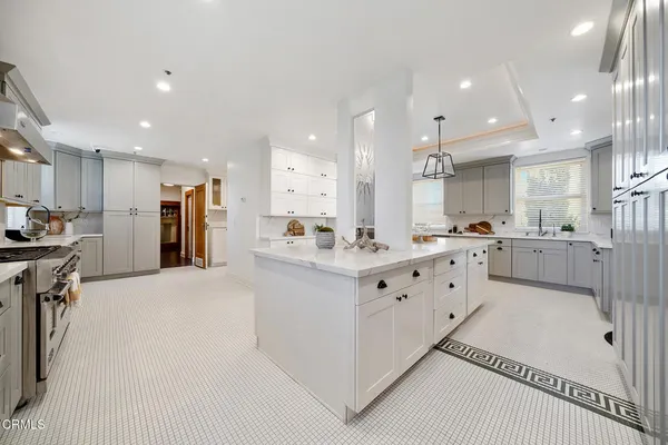 a view of a patio with a table and chairs and a large tree