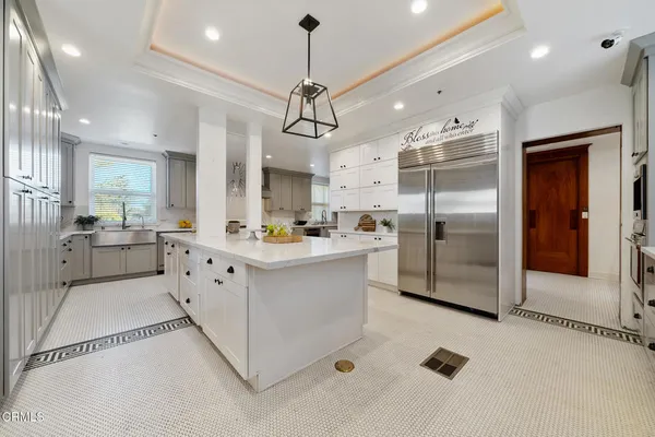 a front view of a house with a garden and plants