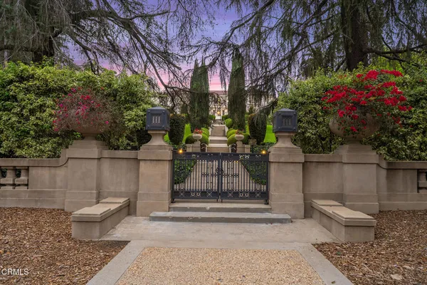 a front view of a house with a garden