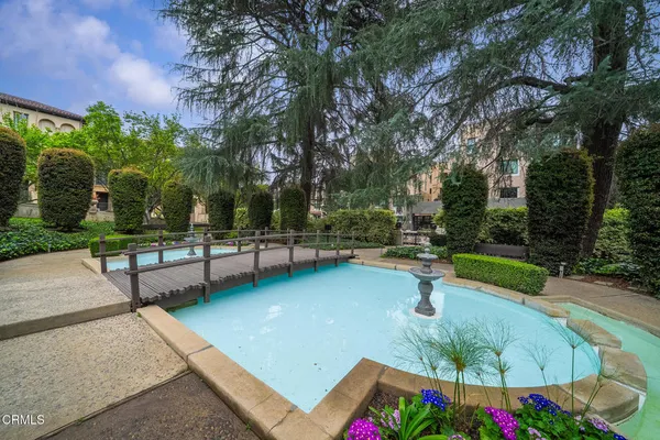 a dining room with furniture a chandelier and wooden floor
