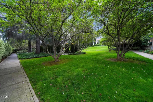 a dining room with furniture a chandelier and wooden floor