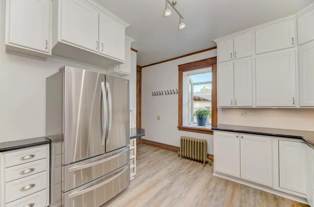 a kitchen with stainless steel appliances granite countertop a refrigerator and a sink