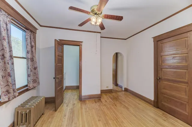 a view of room with window and wooden floor