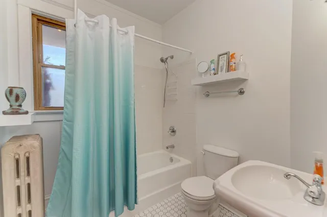 a bathroom with a toilet and a bathtub