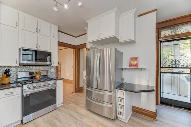 a kitchen with stainless steel appliances a refrigerator stove and microwave
