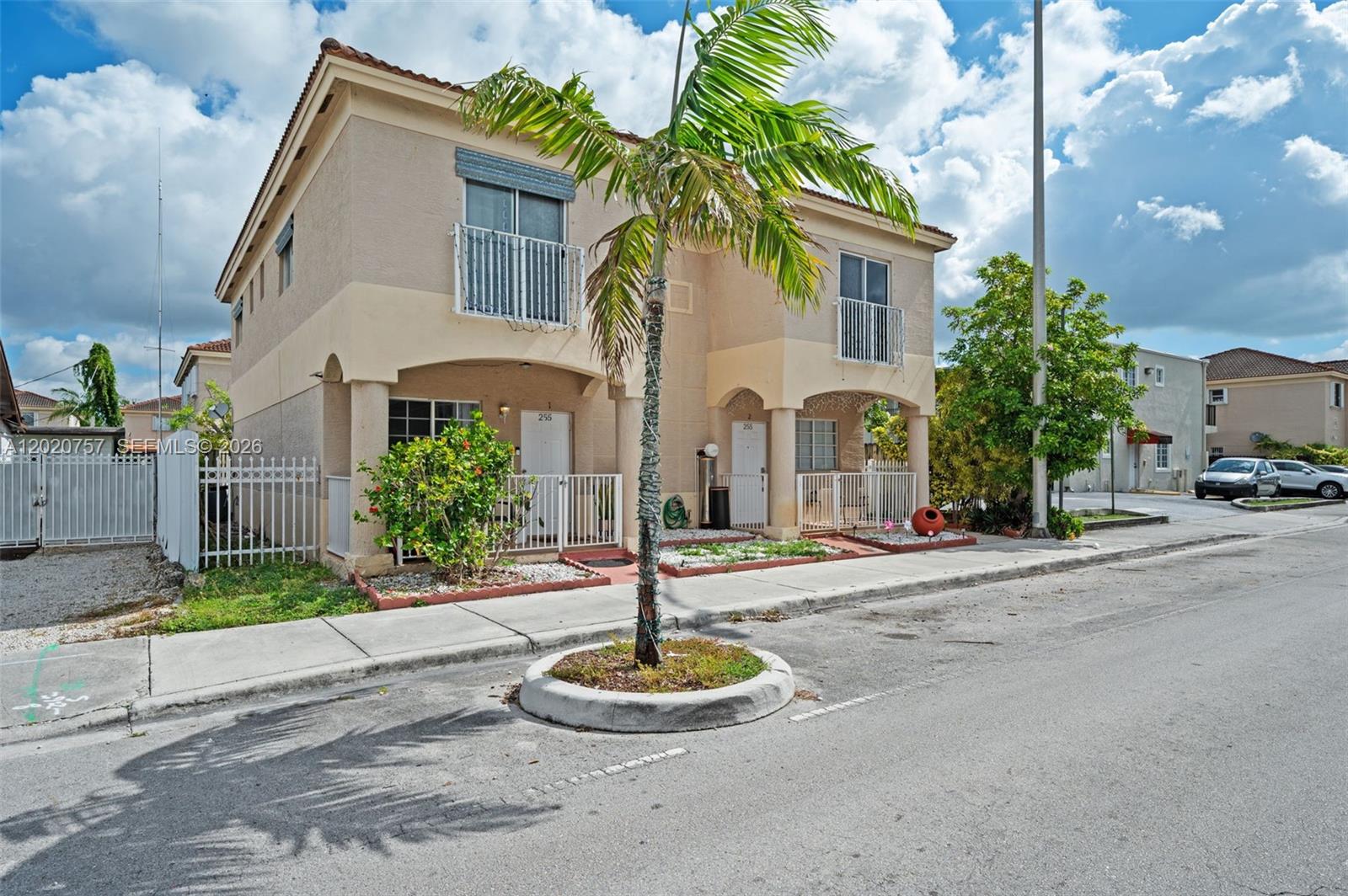 255 East 3rd Street, Unit 1 Hialeah, FL 33010 - Photo 2 of 38 a front view of a house with a yard and a garage