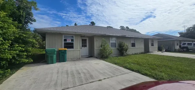 a front view of a house with a yard and porch
