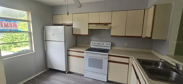a kitchen with a white cabinets and white appliances