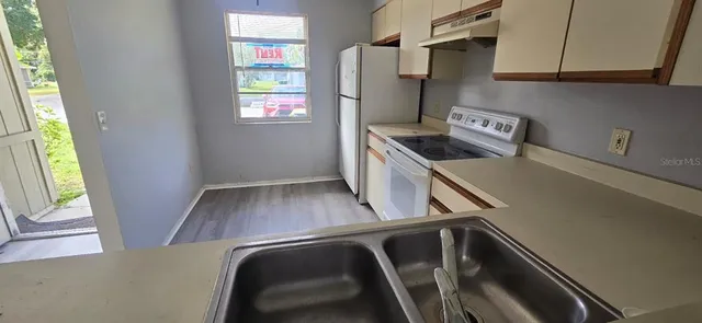 a view of kitchen and wooden floor