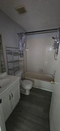 a bathroom with a shower a toilet and a shower