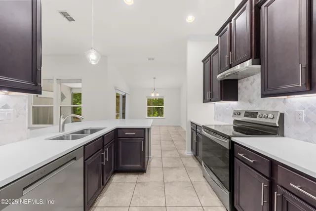 a kitchen with a sink stove and cabinets