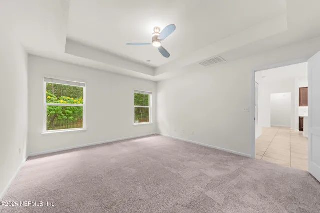 a view of a livingroom with a ceiling fan and window