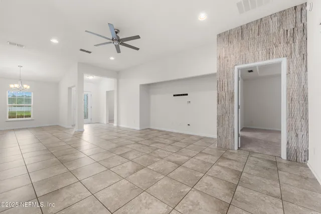 a view of a livingroom with a ceiling fan and window