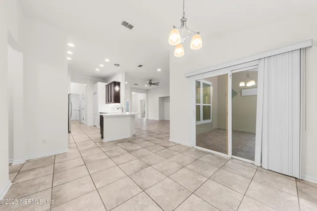 a view of a kitchen with a sink and refrigerator in a kitchen