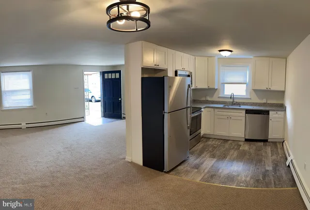 a kitchen with refrigerator and window
