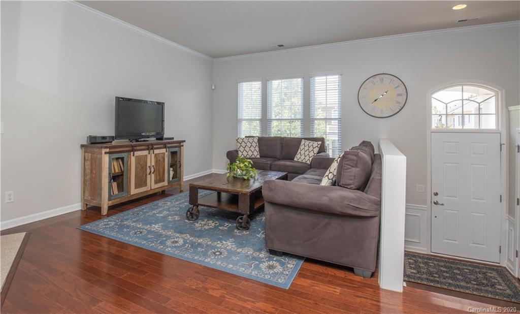 903 Lyndley Drive Fort Mill, SC 29708 - Photo 7 of 47 a living room with furniture a large window and wooden floor