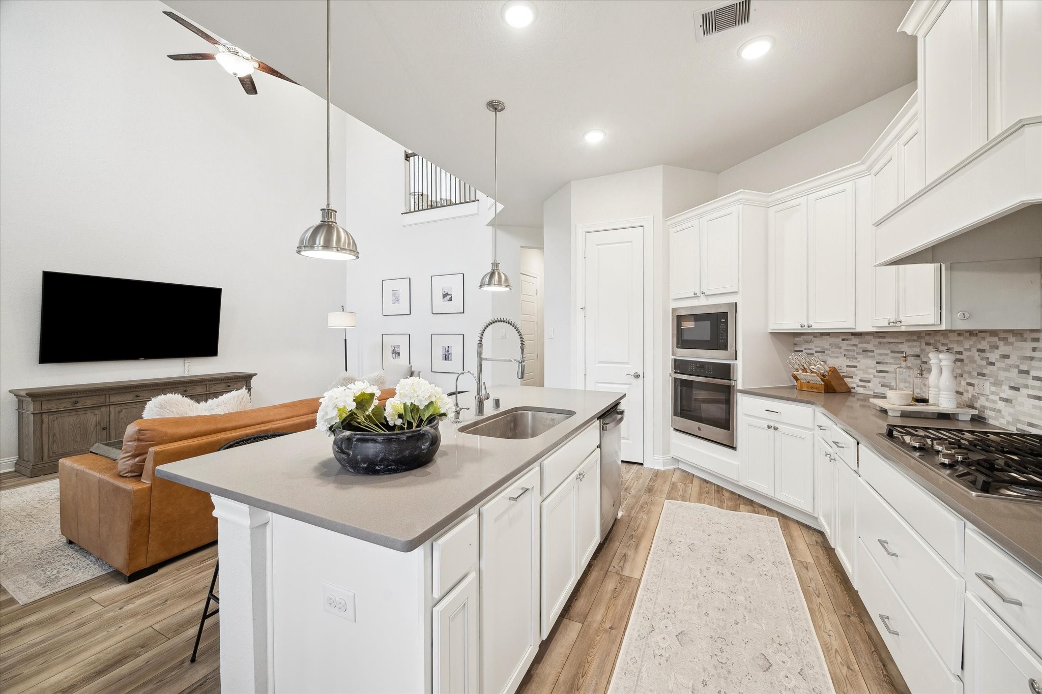 28227 Whitmore Bend Drive Spring, TX 77386 - Photo 14 of 36 Enjoy a functional kitchen with an oversized island sink, pull-out trash drawer, and stainless-steel dishwasher.