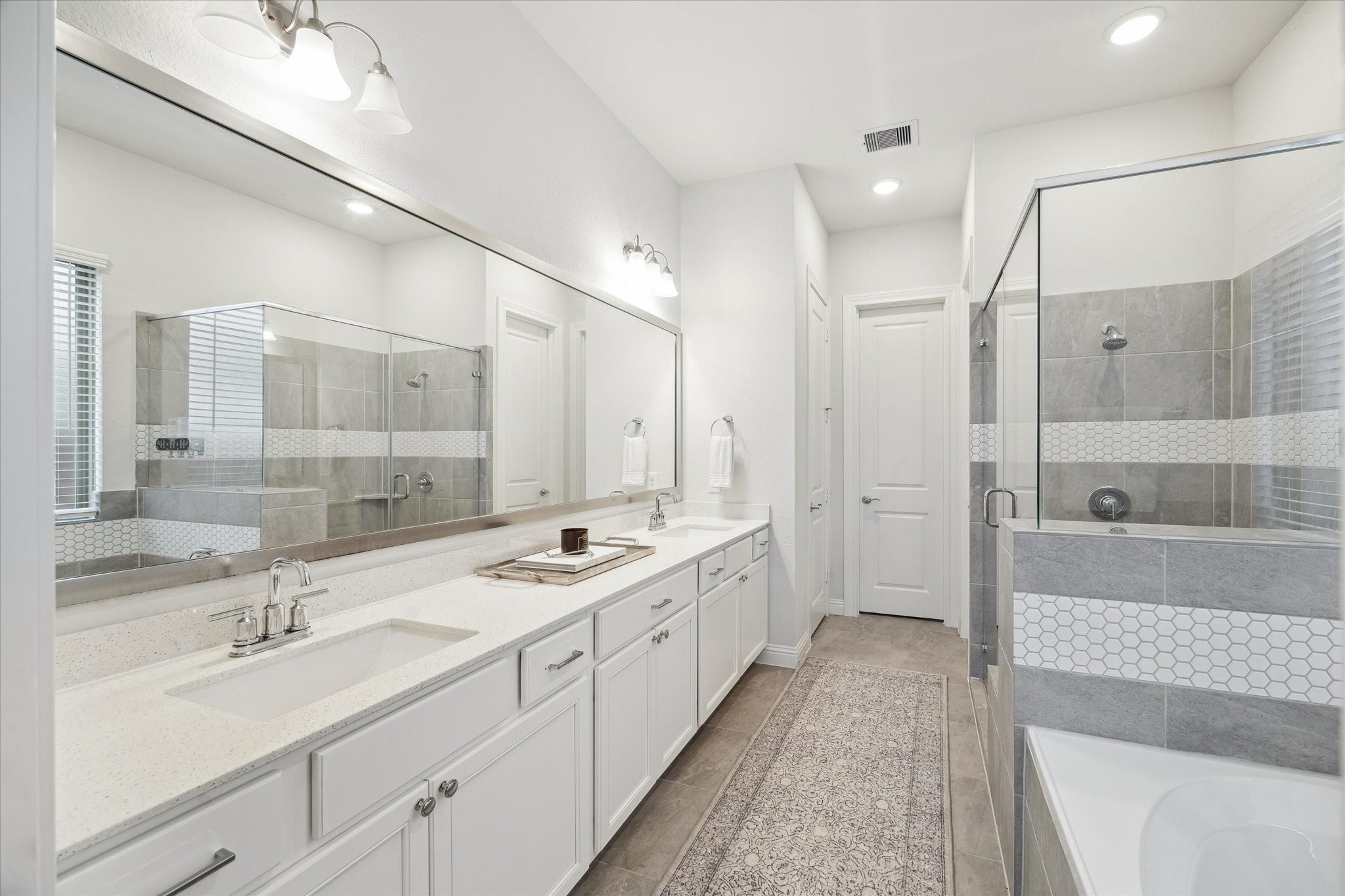 28227 Whitmore Bend Drive Spring, TX 77386 - Photo 18 of 36 The primary bath offers dual sinks, an expansive vanity, and a separate soaking tub and shower.