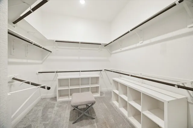 a large room with a bed and a large window