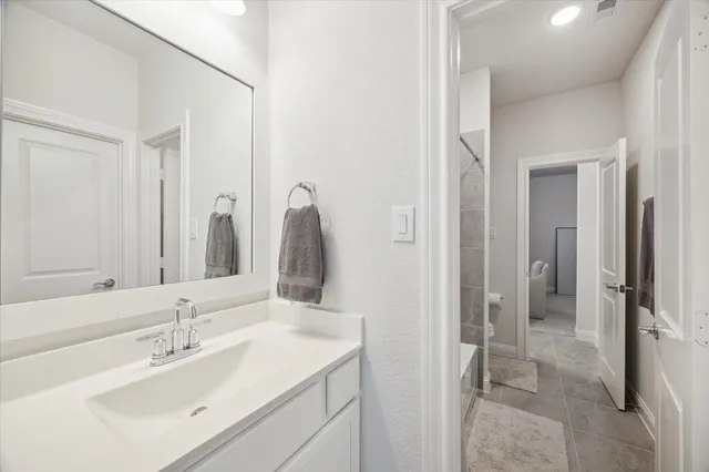 a view of a hallway to a livingroom with furniture