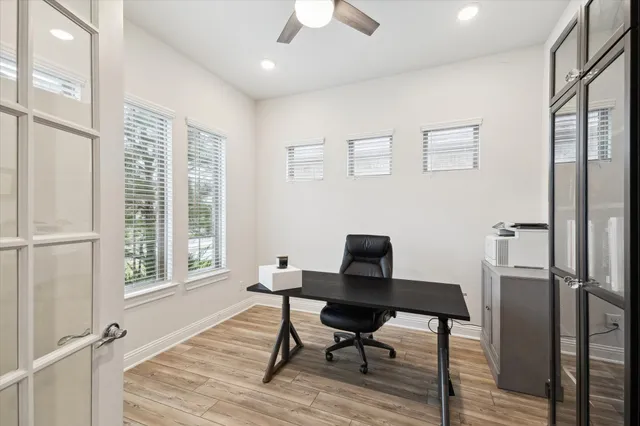 a workspace with furniture a rug and wooden floor