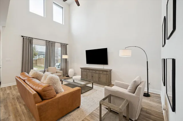 a living room with furniture floor and a flat screen tv