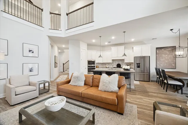a living room with furniture kitchen view and a dining table