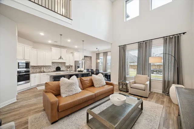 a view of living room kitchen with furniture and wooden floor